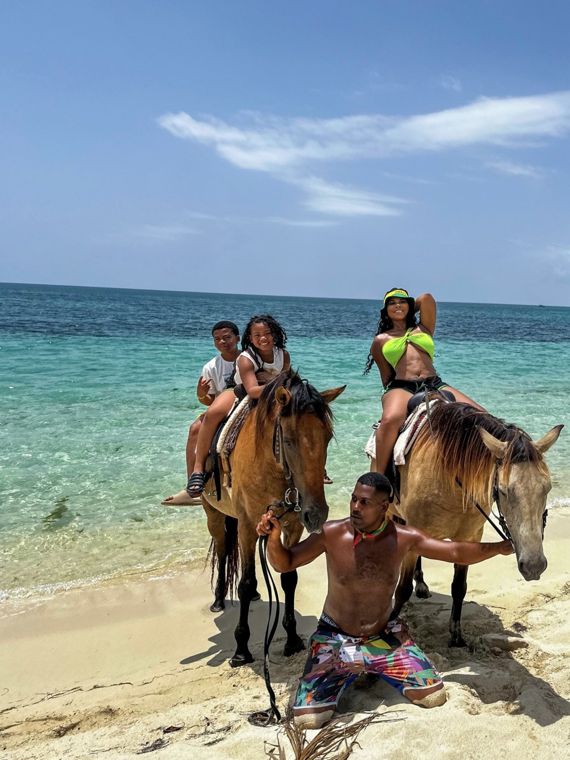 Family enjoying a beach horseback riding excursion