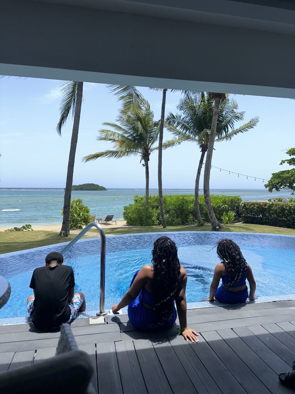 Family relaxing by a resort pool