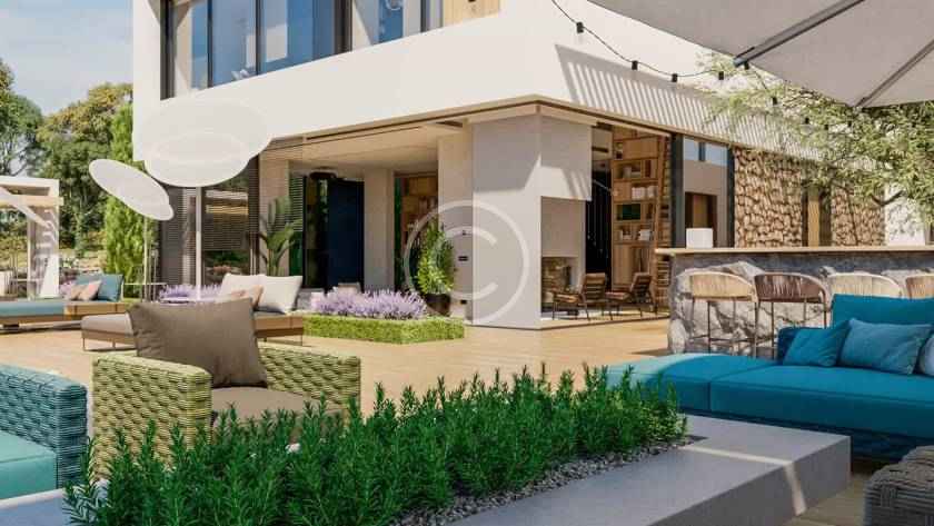 A patio with an umbrella and couch in the background.