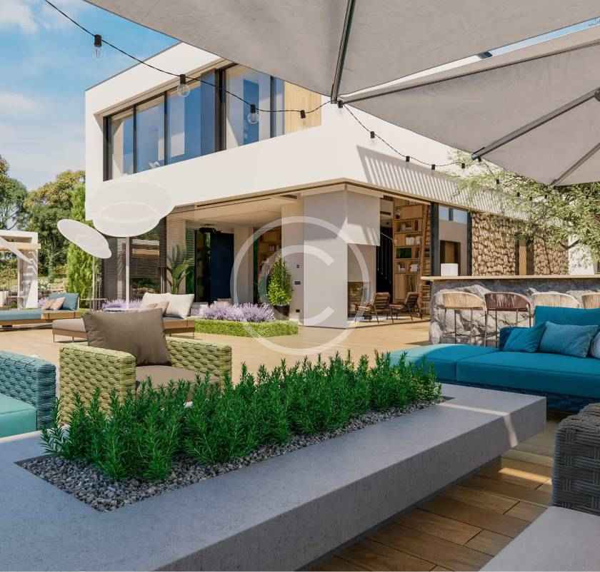 A patio with an umbrella and couch in the background.