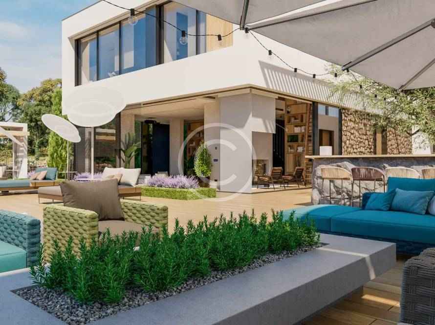 A patio with an umbrella and couch in the background.