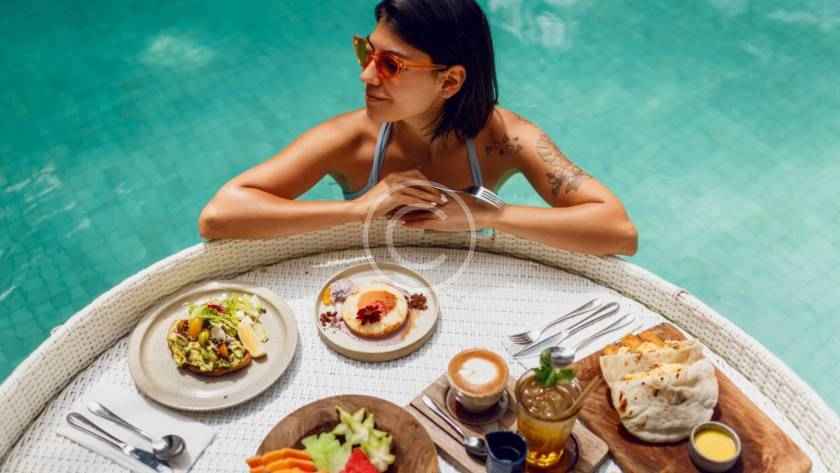 A woman sitting at the table with food on it