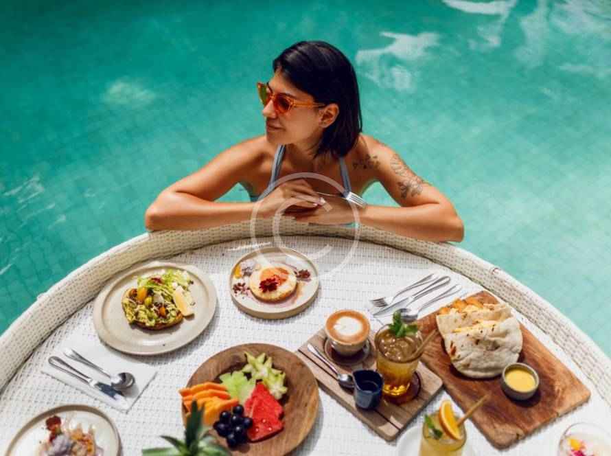 A woman sitting at the table with food on it