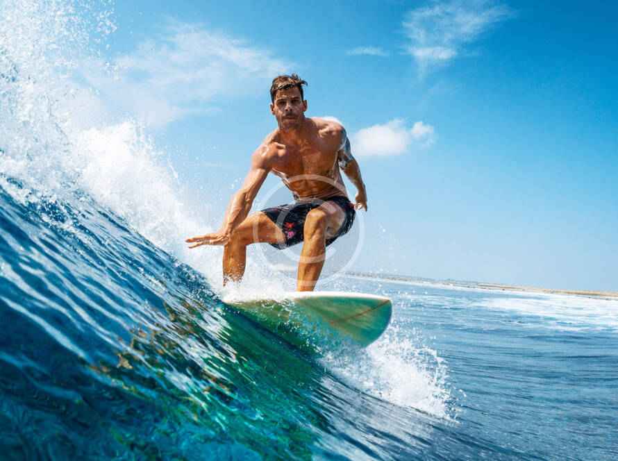 A man riding on top of a surfboard in the ocean.