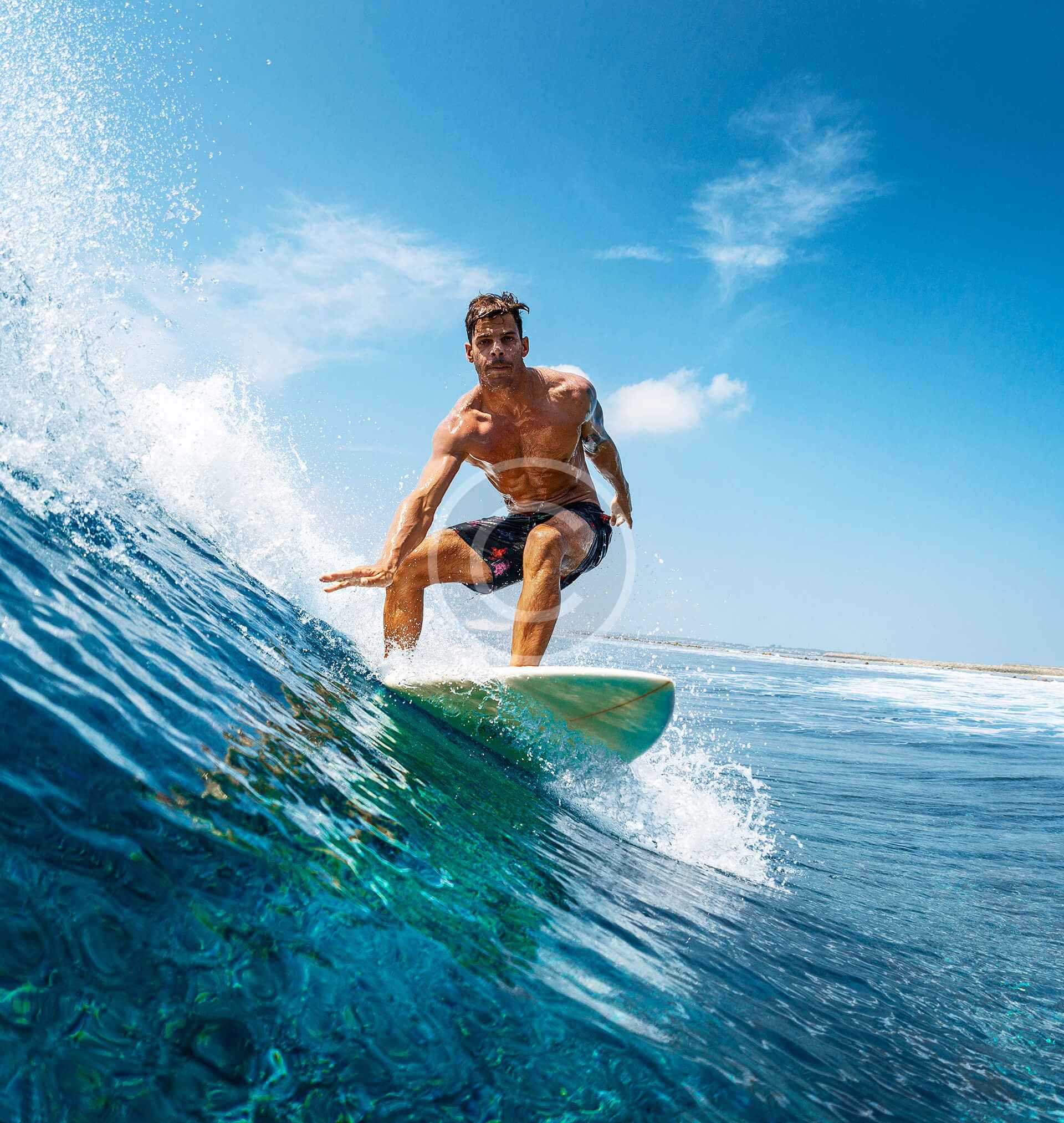 A man riding on top of a surfboard in the ocean.