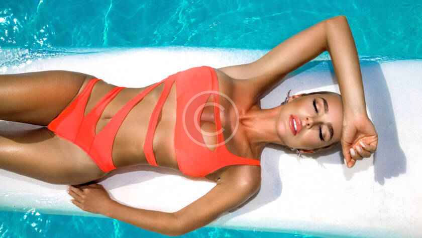 A woman laying on the ground in a pool