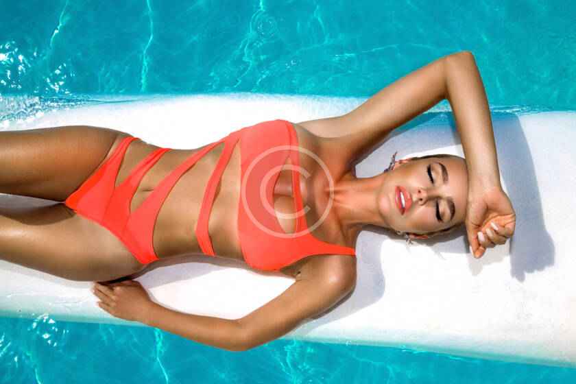 A woman laying on the ground in a pool