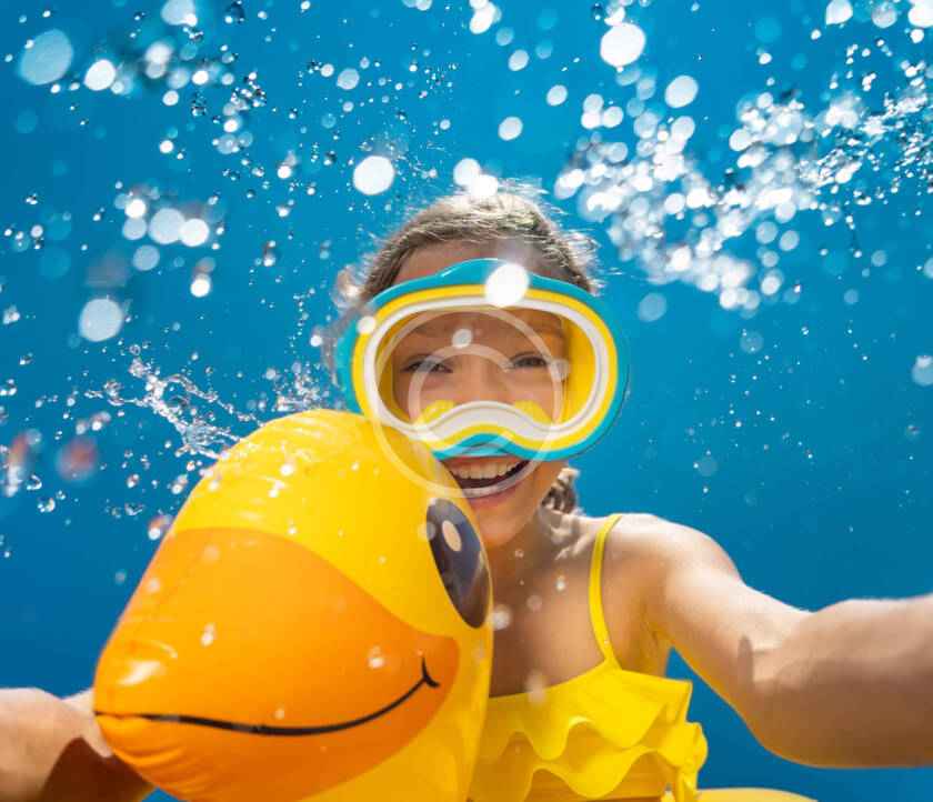 A person in the water with a duck float.