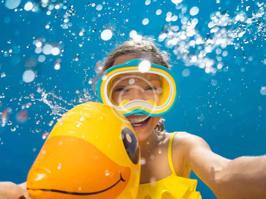 A person in the water with a duck float.