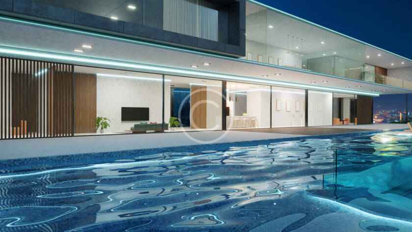 A large swimming pool in front of a house.