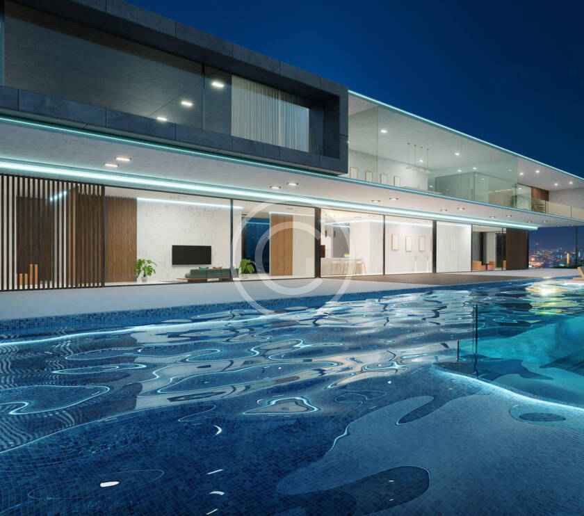 A large swimming pool in front of a house.