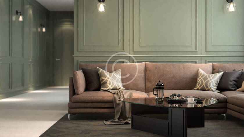 A living room with green walls and brown furniture