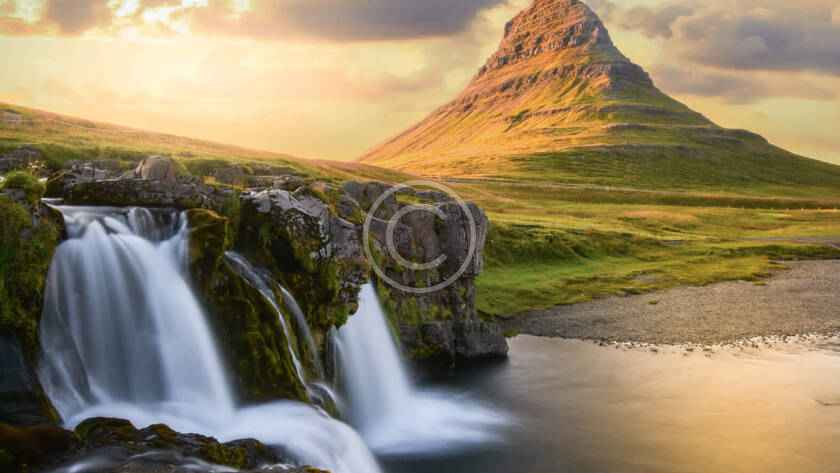 A waterfall and some water in the background