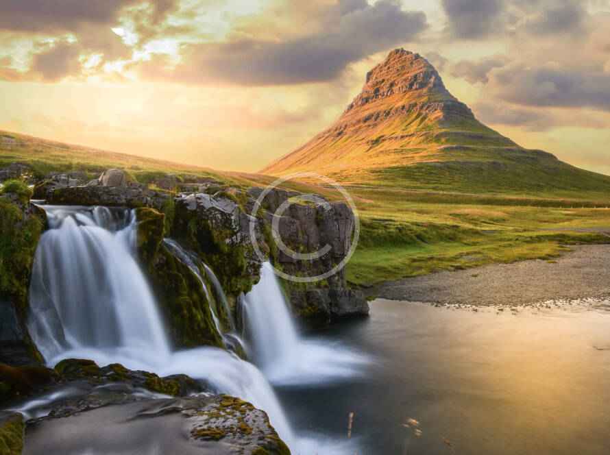 A waterfall and some water in the background