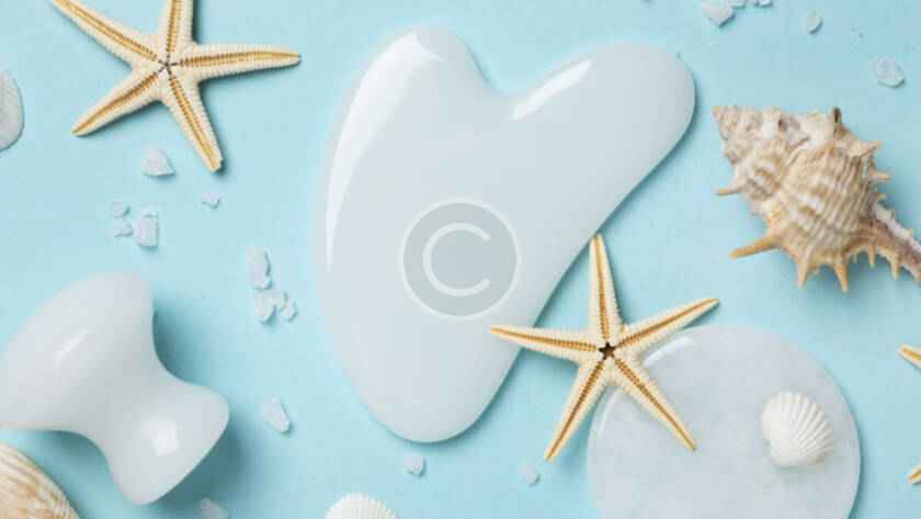 A blue table with shells and lotion on it