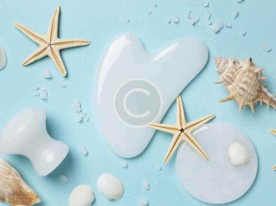 A blue table with shells and lotion on it
