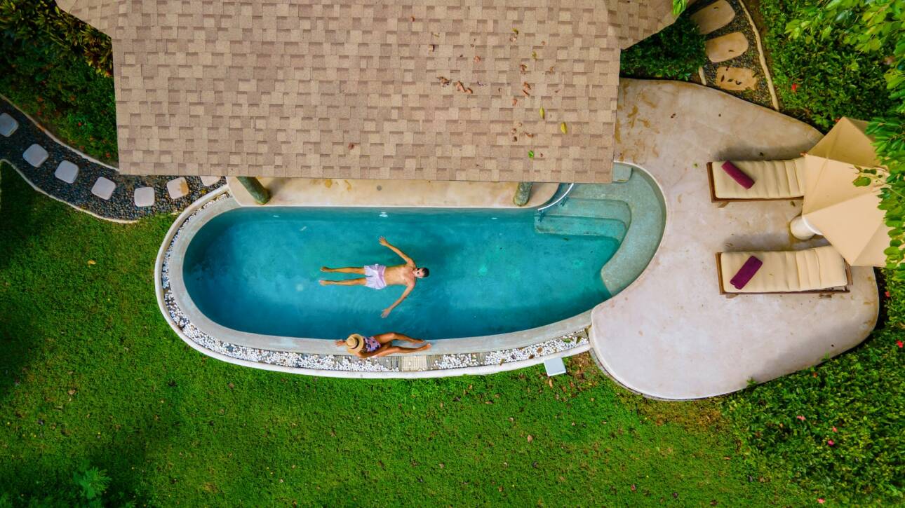 couple men and women on a luxury vacation at a pool villa