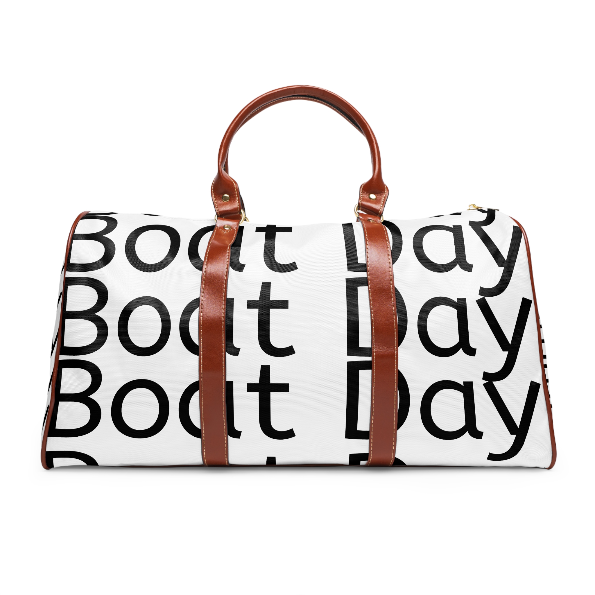 A boat day bag with brown leather handles and a black print.