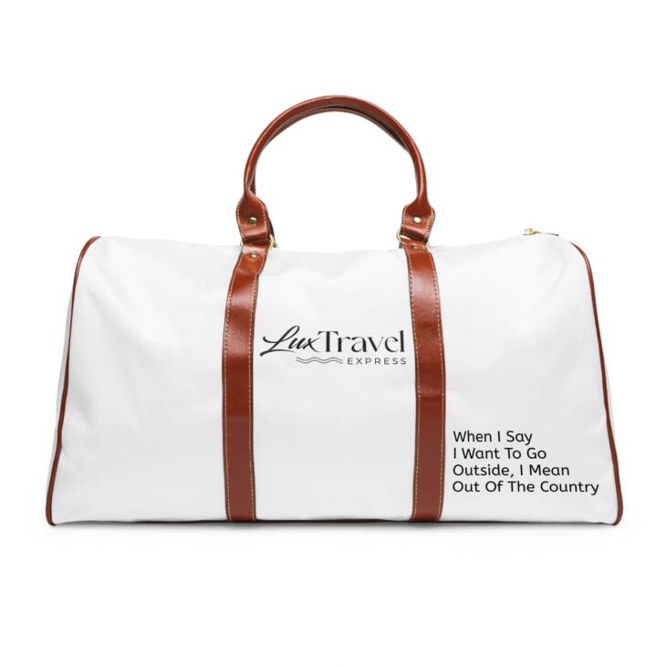 A white duffel bag with brown leather handles.