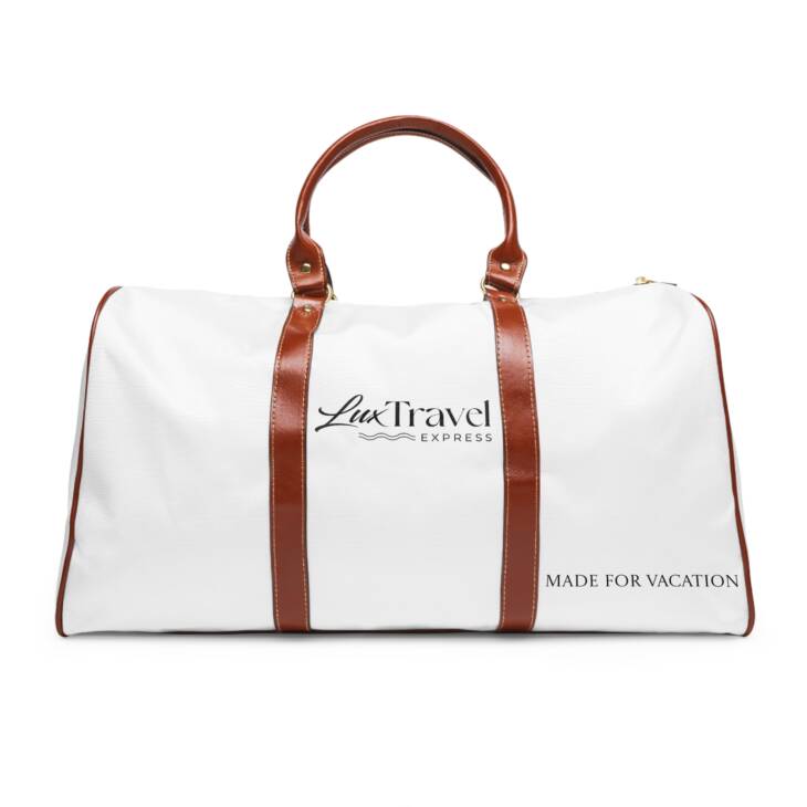 A white duffel bag with brown leather handles.